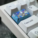 Collection of Vibrant Jinhsi Anime Titanium Keycaps, showcasing premium metal craftsmanship and intricate stylized art from multiple angles.