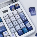 Artisan Kaeya Genshin Impact keycap set displayed from multiple angles, featuring icy blues, noble gold, and dark accents that capture elegant mystique design.