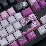 Detailed shot of the enigmatic Kafka double-shot PBT keycap set, revealing its sleek purple and black side-printed legends from a distinct angle.