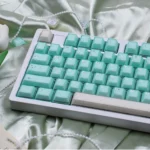 Product gallery showcasing the Ethereal Shimmering Translucent Magnetic Keycaps Set, highlighting their jade elegance and crystal-like glow.
