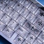 Ethereal translucent white Frosted PC Magnetic Keycaps Set, Cherry profile. Rebellious elegance with gothic contours shown from diverse angles.