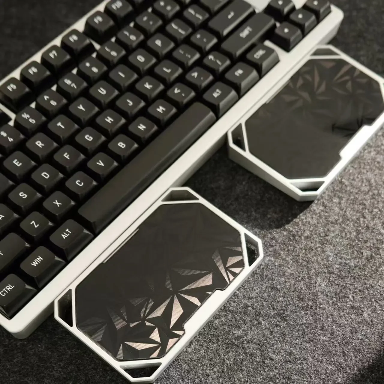 Sleek anodized black modular aluminum wrist rest for mechanical keyboards, highlighting its premium design and ergonomic split for customizable
