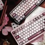 A close-up view of artisan moth keycaps set revealing ethereal wing patterns and deep twilight hues, emphasizing their exquisite dreamlike craftsmanship.