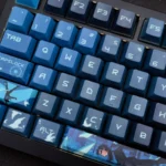 Exclusive Nightwing Spirit artisan keycap set gallery, showcasing its sleek dark blue and black finish, iconic emblem, and Cherry profile from multiple angles.