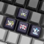 Vibrant gallery images of the One Piece Pirate Flag PBT keycap set from various angles. These premium dye-sublimated keycaps feature iconic pirate design.