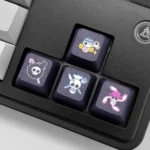 Explore the premium PBT dye-sublimated One Piece Pirate Flag keycaps, featuring iconic emblems across various angles. Perfect for an epic gaming setup.