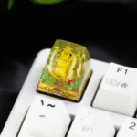 Detailed view of the playful, handcrafted Pokemon: Iconic Pikachu Transparent Keycap, featuring its glossy resin finish and whimsical underwater theme for mechanical keyboard.