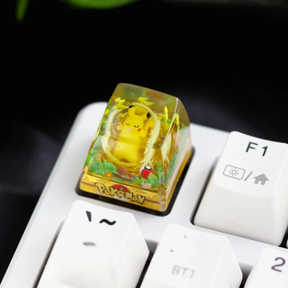 Detailed view of the playful, handcrafted Pokemon: Iconic Pikachu Transparent Keycap, featuring its glossy resin finish and whimsical underwater theme for mechanical keyboard.