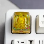Handcrafted Pokemon: Iconic Pikachu Transparent Keycap, a vibrant resin charm for mechanical keyboards, featuring a glossy finish in a whimsical adventure theme.