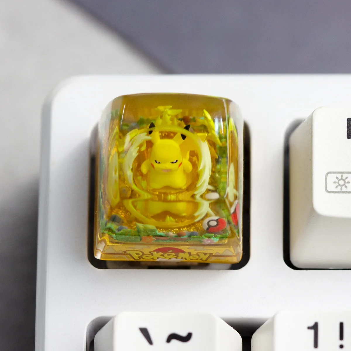 Handcrafted Pokemon: Iconic Pikachu Transparent Keycap, a vibrant resin charm for mechanical keyboards, featuring a glossy finish in a whimsical adventure theme.
