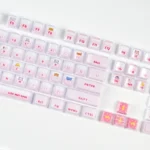 Whimsical peek-a-boo pink cat artisan keycap set with a sparkling crystal jelly finish, shown from various angles on a mechanical keyboard.