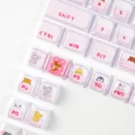 Gallery of whimsical pink cat keycaps set, highlighting their translucent crystal jelly aesthetic, playful peek-a-boo cat, and sweet pink hues.