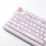 Playful pink peek-a-boo cat keycap set for mechanical keyboards, featuring a whimsical crystal jelly design shown from multiple angles.