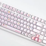 A delightful collection of pink peek-a-boo cat keycaps set, showcasing the whimsical crystal jelly design and translucent finish from various angles.
