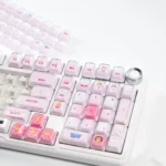 Playful pink cat keycap set in a crystal jelly style, showcased from multiple angles. This whimsical artisan keycap adds a sweet touch to any mechanical keyboard.