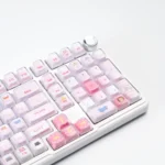 A whimsical gallery of the pink cat keycap set, showing off its cute peek-a-boo cat design and radiant crystal jelly finish from every delightful angle.