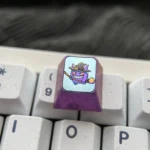 Premium titanium Pokemon Halloween ESC keycap featuring a vibrant ghost Pokemon in a spooky costume with intricate metallic details.