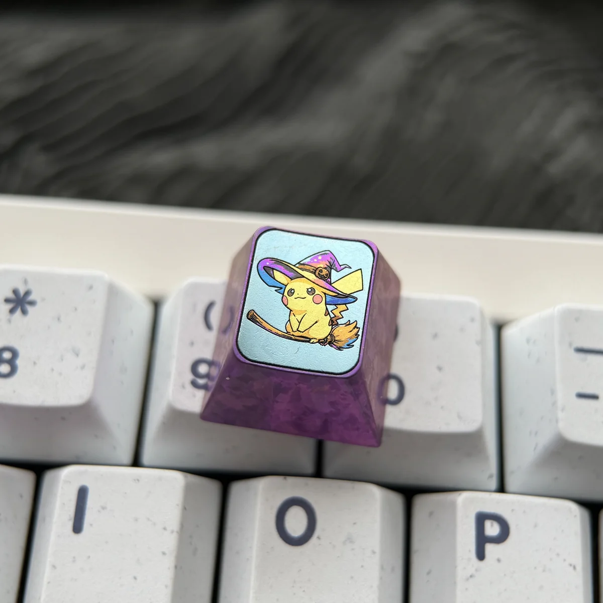 Premium titanium Pokemon Halloween ESC keycap with a vibrant, intricately detailed Pikachu in a ghost costume, highlighting its metallic finish.