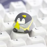 Whimsical green positive penguin keycap, handcrafted from smooth resin, adding a vibrant and artistic touch to your mechanical keyboard setup.