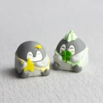 Handcrafted resin Positive Penguin Charm ESC keycap gallery. Whimsical green penguin and smooth, vibrant finish visible from all angles.