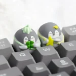 Whimsical green penguin handcrafted resin keycap, a smooth, vibrant custom ESC keycap bringing positive charm to any mechanical keyboard setup.