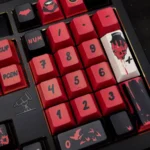Premium Red Hood keycaps set, photographed from multiple angles, highlights the iconic DC vigilante spirit and bold red and black design.