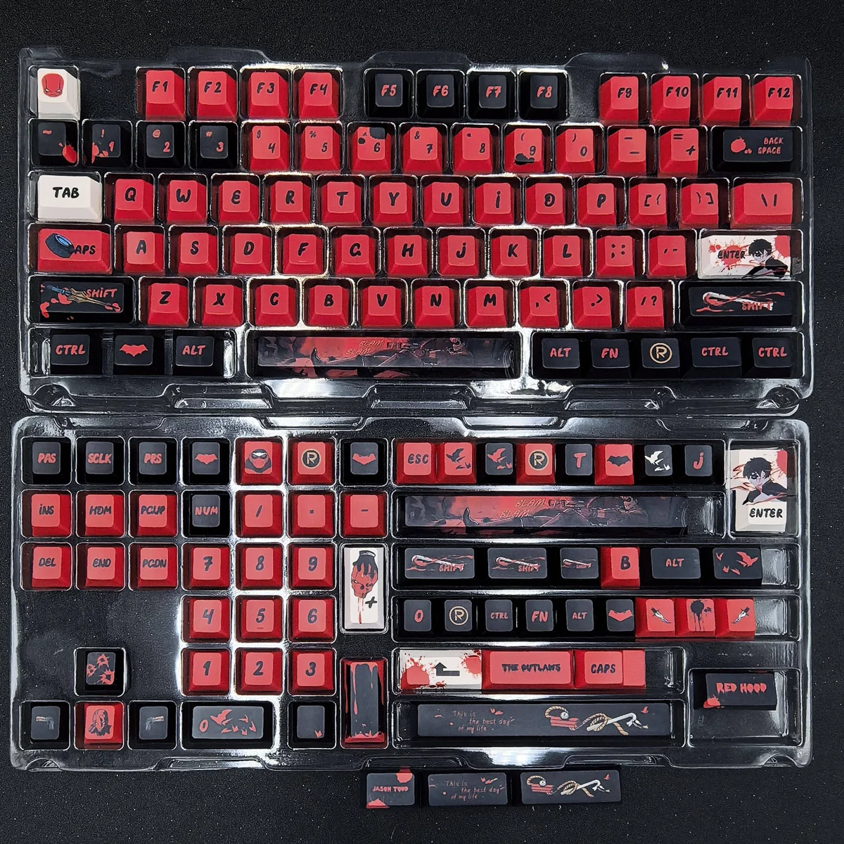 A close-up view of the premium Red Hood keycaps set, showcasing the intricate DC vigilante iconography and bold red and black design from a side angle.