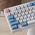 Exclusive Re:Zero Rem PBT dye-sub keycaps set, artfully displayed in a charming close-up, highlighting vibrant blue-white maid motifs.