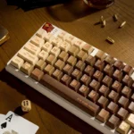 Revolver Keycap Set: Distinctive PBT custom keycaps shown from various angles. Features vintage revolver motifs, industrial details, and adventurous.