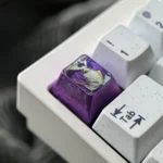 Premium Reze Titanium Keycap, viewed from multiple angles, showcasing the polished alloy, explosive purple ice crystal design, and iconic Chainsaw Man design.