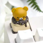 Close-up of an adorable Rilakkuma Donut artisan keycap, featuring the iconic character in vibrant, handcrafted resin for ESC keys.
