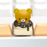 Adorable Rilakkuma Donut artisan keycap for mechanical keyboards, showcasing vibrant handcrafted details from various angles.