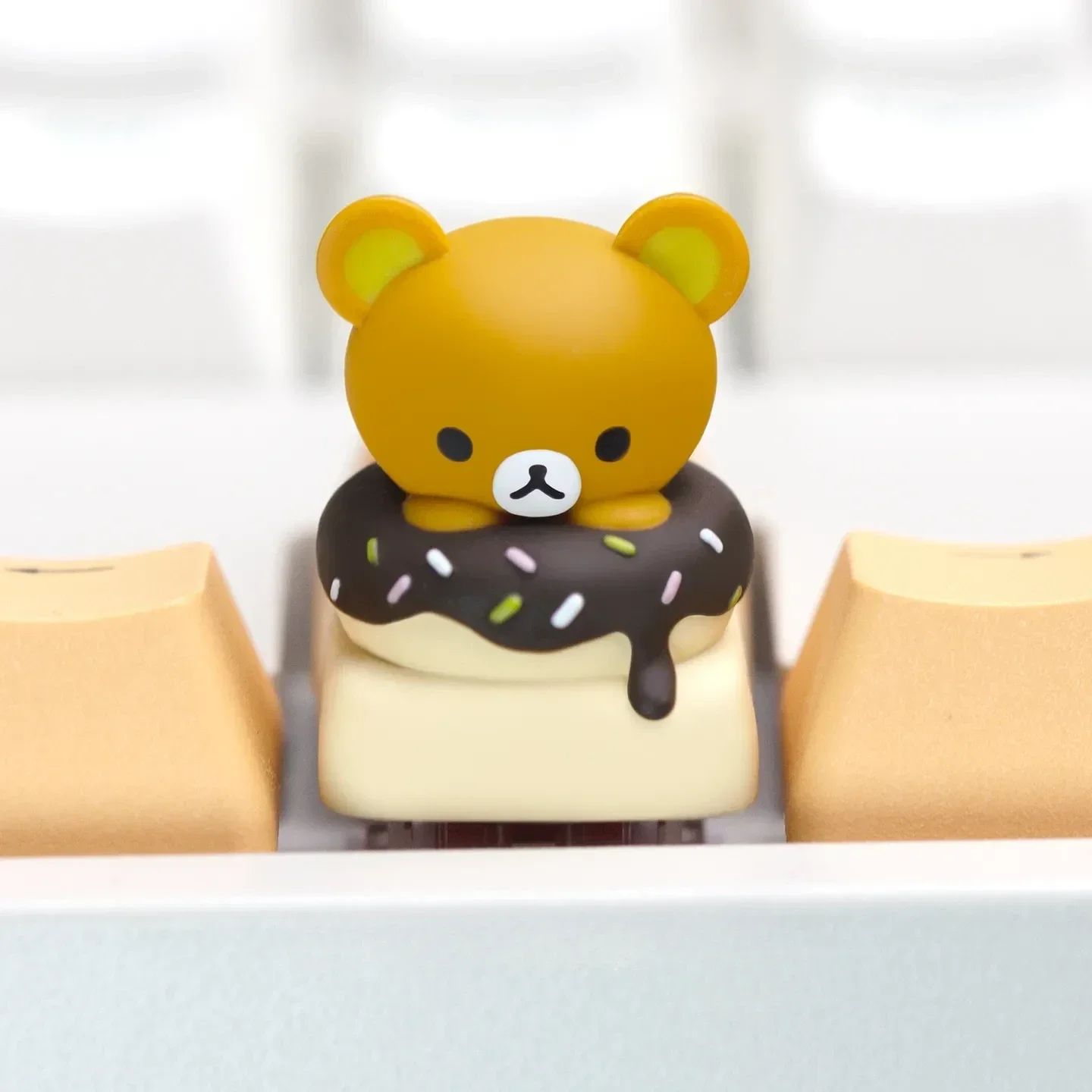 Adorable Rilakkuma Donut artisan keycap for mechanical keyboards, showcasing vibrant handcrafted details from various angles.