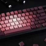 A collection of enchanting rose keycaps set showcasing their luminous PBT gradient, delicate pink and green floral designs, and side-translucent glow.