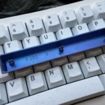 Roxy Keycap Titanium Space key keycap. Artisan anime art on polished titanium, vibrant, shown from multiple angles for custom keyboards.