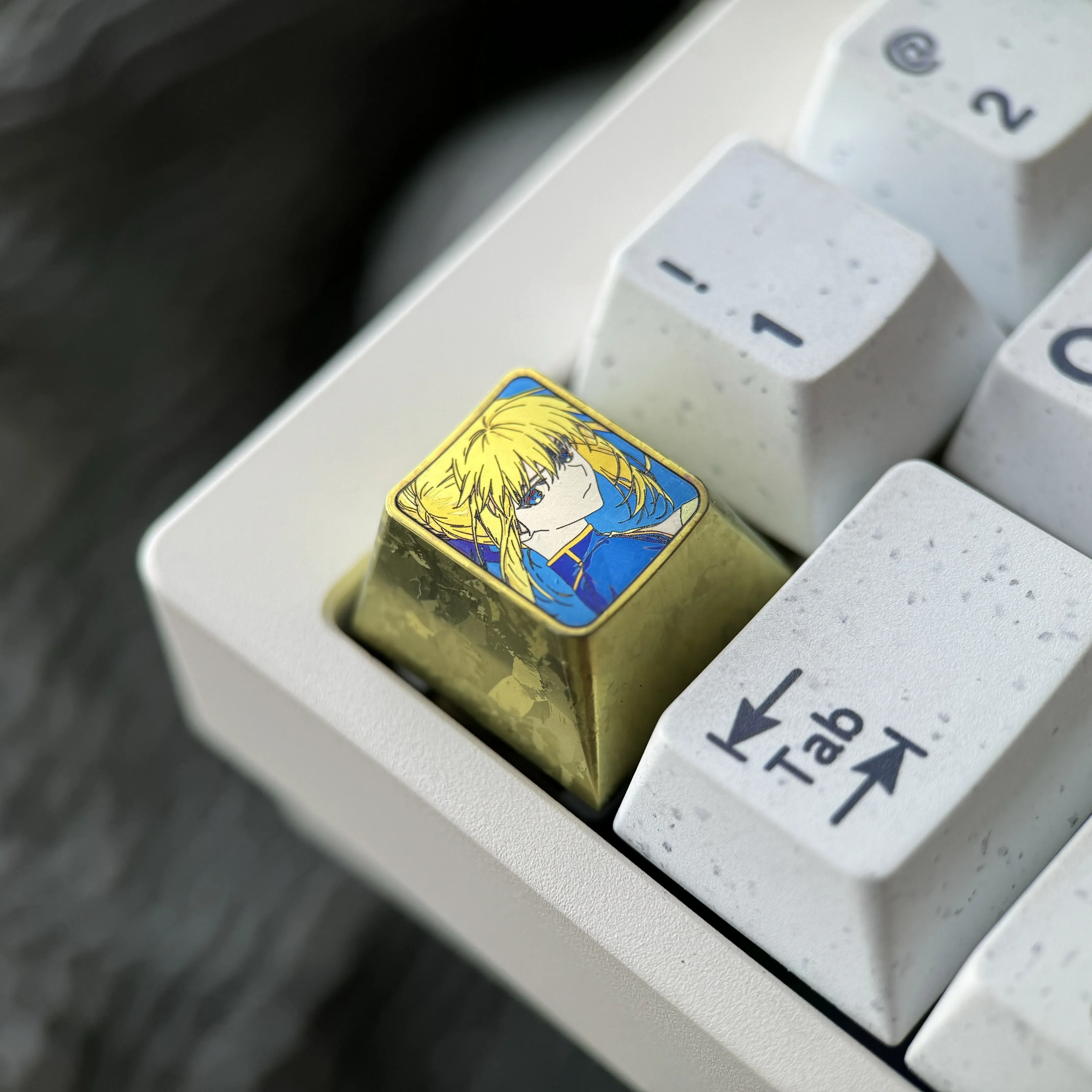 Collection of vibrant Saber titanium alloy keycaps, showcasing artisan anime design and anodized finish from multiple angles for mechanical keyboards.