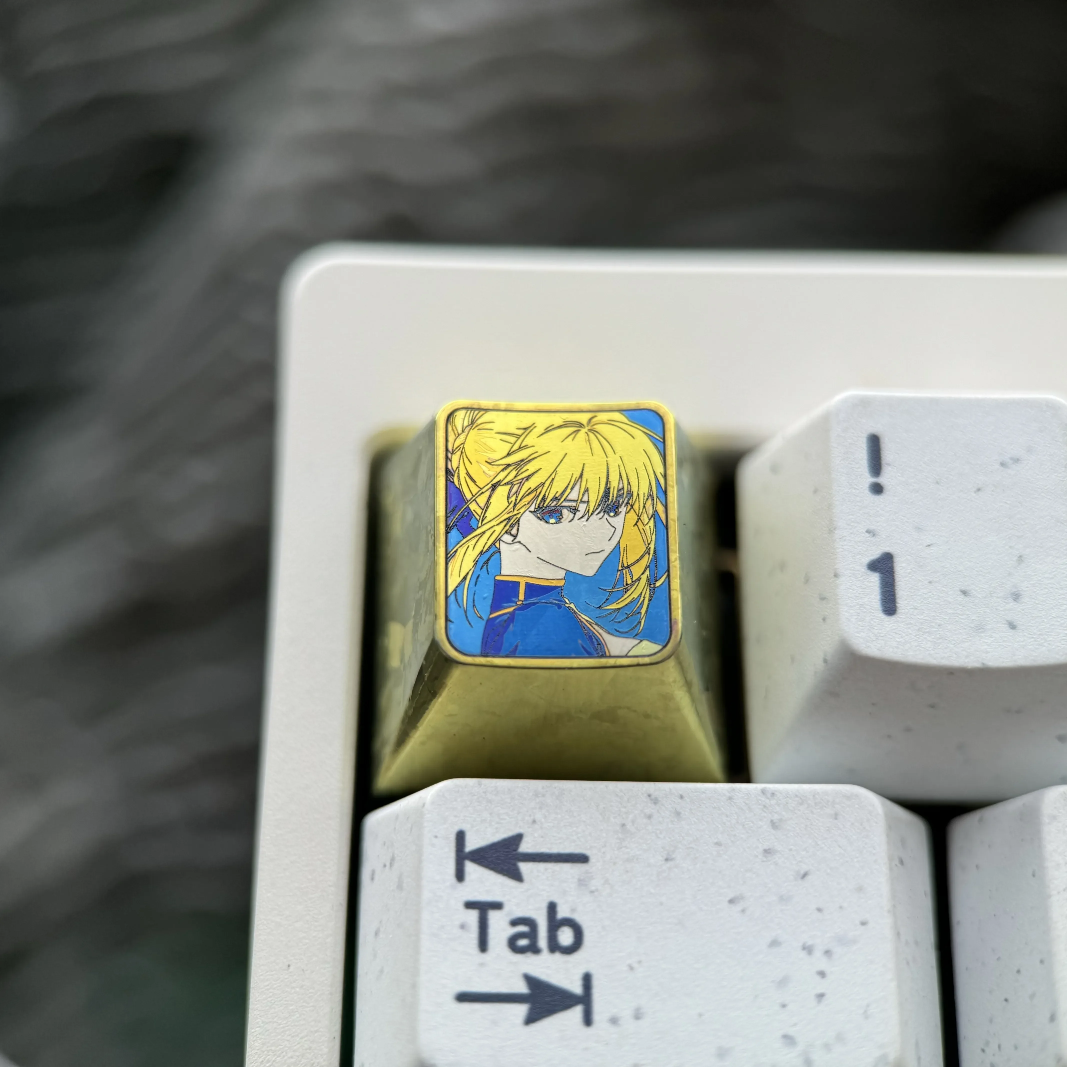 Vibrant Saber titanium alloy keycap for mechanical keyboards, showcasing artisan anime design with a premium anodized finish.