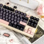 A collection of Ethereal Night Sakura Pink Translucent PBT+PC Double-Shot keycaps set displayed from multiple angles, showcasing their delicate glow.