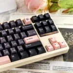Showcasing the Ethereal Night Sakura Pink translucent PBT+PC double-shot keycaps full set from various angles, highlighting their dreamy glow.
