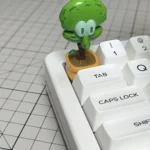 A unique handcrafted resin whimsical Squidward potted plant artisan keycap, shown from a delightful new angle, emphasizing its charming details.
