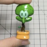 Whimsical Squidward potted plant artisan keycap, meticulously handcrafted in resin, presented from a delightful, unique perspective.