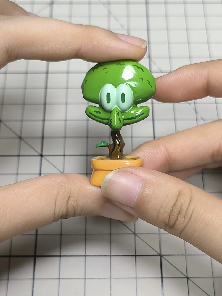 A unique handcrafted resin Squidward potted plant artisan keycap, whimsically designed for mechanical keyboards, bringing pop-culture charm to your desk.