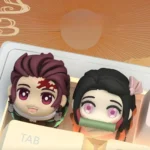 Exclusive handcrafted 3D Tanjiro Demon Slayer keycap shown from multiple angles, revealing vibrant sculpt and intricate artisan details.