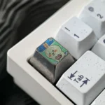 Artistic gallery of the Premium Titanium Anime Keycap, featuring the whimsical Usagi ESC design with vibrant colors and stunning metallic finish.