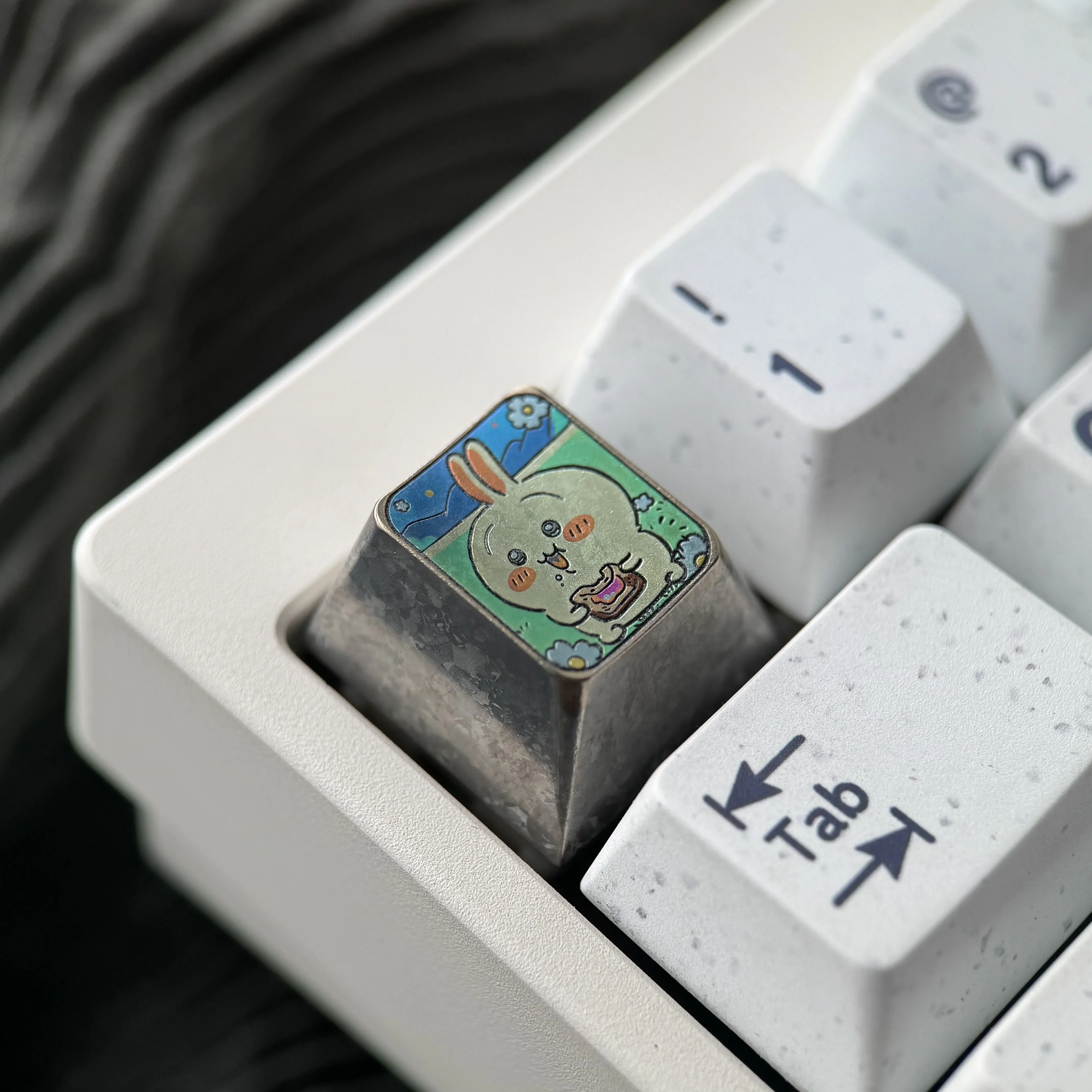 Artistic gallery of the Premium Titanium Anime Keycap, featuring the whimsical Usagi ESC design with vibrant colors and stunning metallic finish.