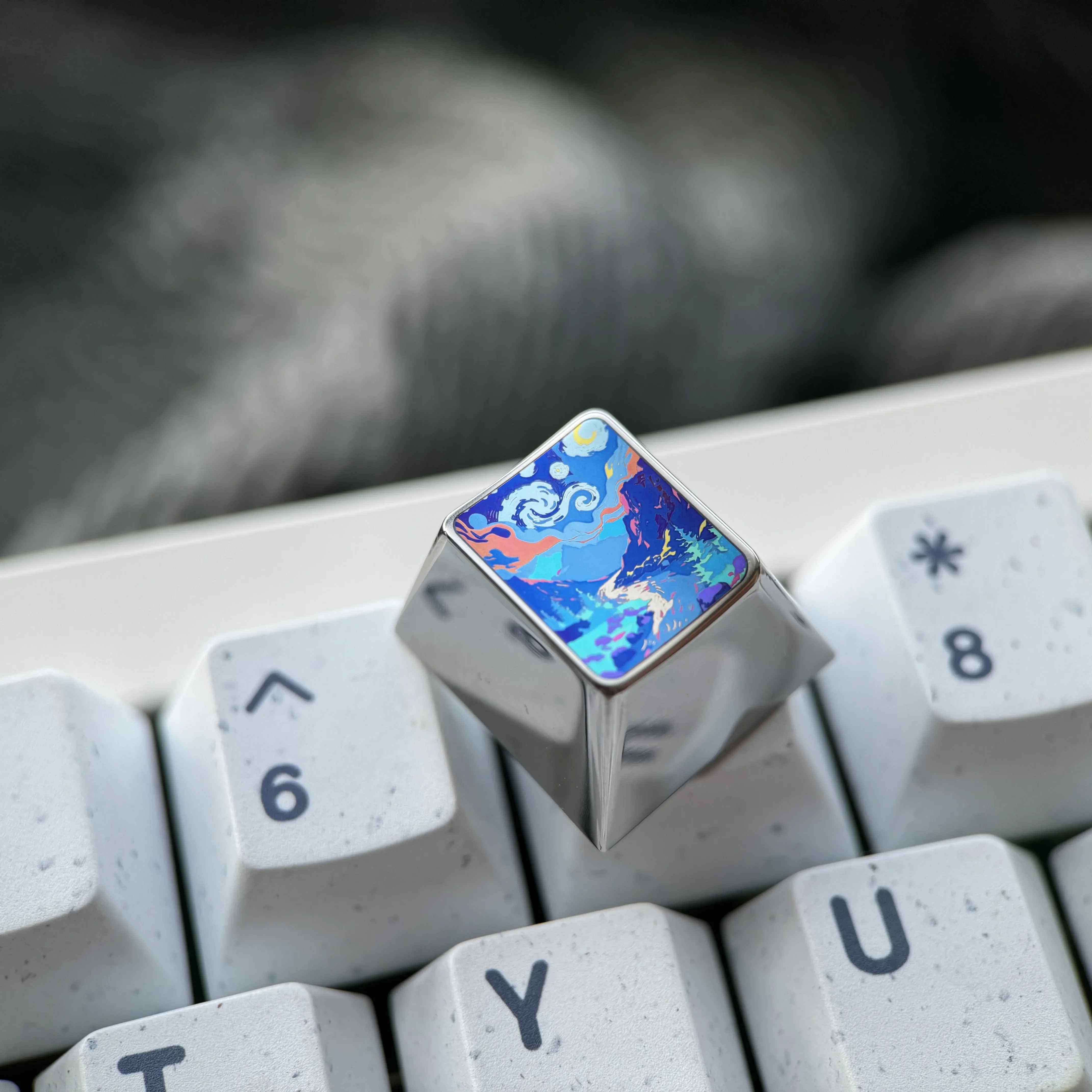 Multiple views of the handcrafted sculpted titanium mountain valley artisan keycap, featuring its vibrant, fade-resistant finish.