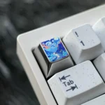 Handcrafted titanium mountain valley artisan keycap. Fade-resistant, with intricate topographical peaks and vibrant anodized metallic texture.