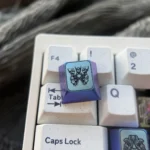 Titanium Gundam WASD gaming keycaps from multiple angles, highlighting their intricate futuristic design and vibrant anodized finish.