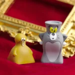 Close-up of a handcrafted Tom Jerry resin artisan keycap, showcasing the whimsical 3D art from various angles with nostalgic cartoon charm.