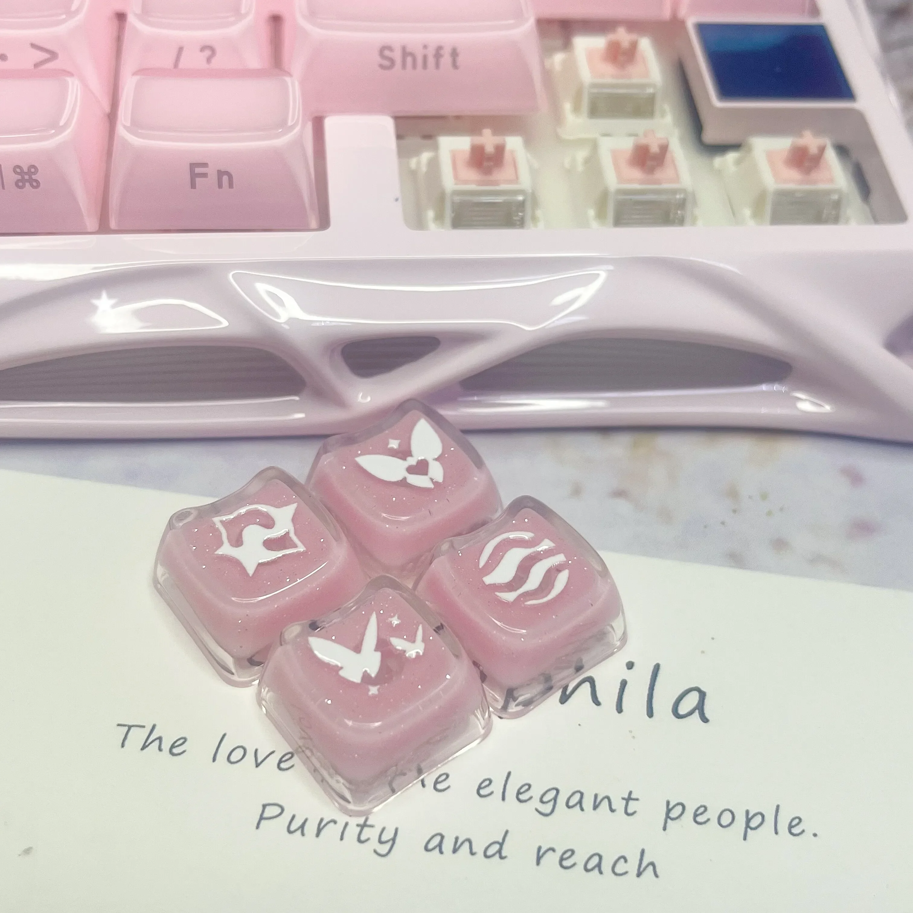 Enchanting Valorant keycaps glisten with translucent pink glitter, perfect for mechanical keyboard skill keys.